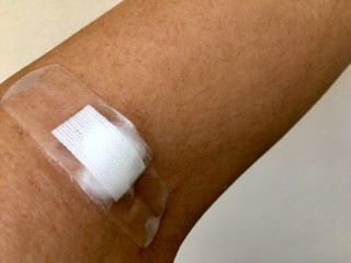 Plaster and cotton patch on the arm after the blood test.