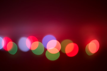 colorful blurred bokeh lights on a red-brown background