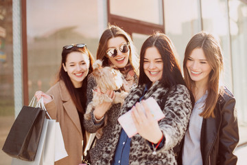 Happy young woman make selfies with shopping bags