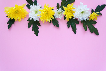 bouquet of white and yellow chrysanthemums on a pale pink background