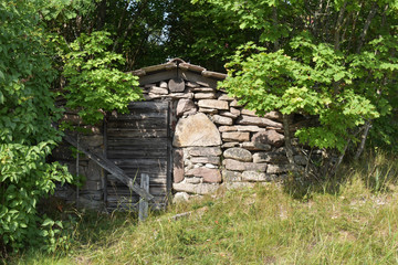 House made of rocks and wooden door hidden in the forest