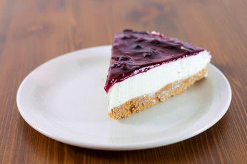 Raspberry cheesecake on wooden table