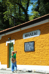 Girl looking at the timetable of an old train station