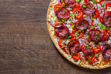 Pepperoni Pizza with Mozzarella cheese, salami, Tomato sauce, pepper, onion, Spices. Italian pizza on wooden table background