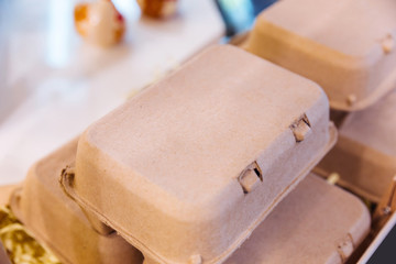 Brown chicken eggs in a brown carton box.