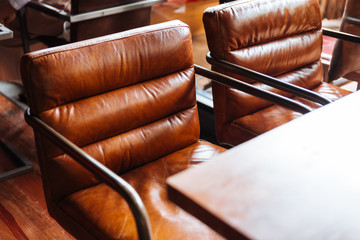 Leather chairs with wooden top table.