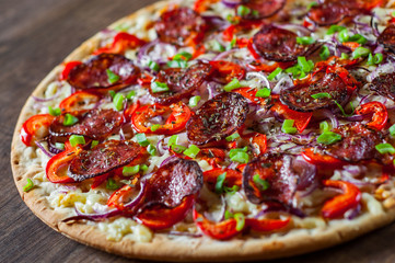Pepperoni Pizza with Mozzarella cheese, salami, Tomato sauce, pepper, onion, Spices. Italian pizza on wooden table background
