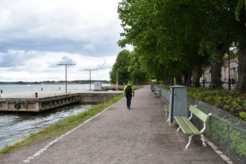 Person walking at the park beside a body of water