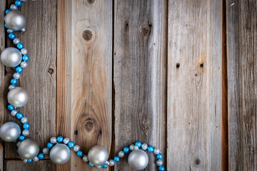 little blue and silver Christmas balls on rustic wood background