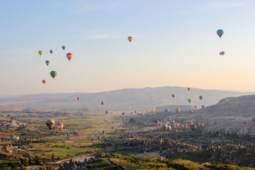 hot air balloon flying over fields