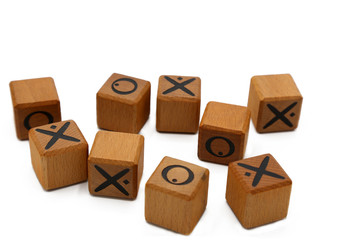 Tic tac toe cubes. X and O game.Wooden cubes on white background.