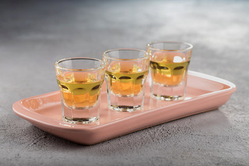 Close-up shot of three glasses of Golden tequila.