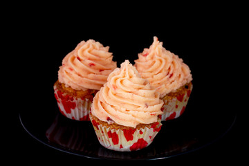 Fresh baked delicious different cupcakes served together with isolated black background