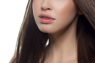 Beauty closeup of women full red lips with shiny skin and long hair. Facial skin care in a spa salon or cosmetology and a fashionable natural lip gloss or lipstick. Day makeup