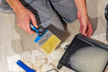 construction worker prepares the glue for Wallpaper