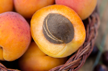 Delicious ripe apricots in a basket on rustic background. Healthy foods. Close up. Flat lay Top view.
