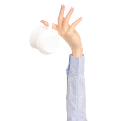 White cup mug in hand arm raised up on white background isolation