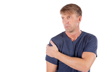 Obraz premium Man holding his sore shoulder trying to relieve pain on white background. Health problems