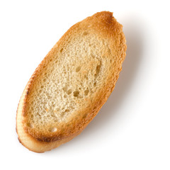 Toasted baguette slice isolated on white background close up.  Toast, crouton.   Top view.