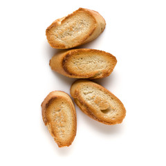 Toasted baguette slices isolated on white background close up.  Toast, crouton.   Top view.