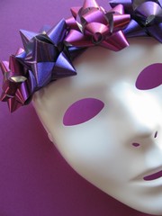 White mask in crown of shiny purple bows, spirit of the Xmas-New Year holidays