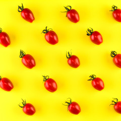 Food pattern of cherry tomato  isolated on yellow background. Flat lay, top view.