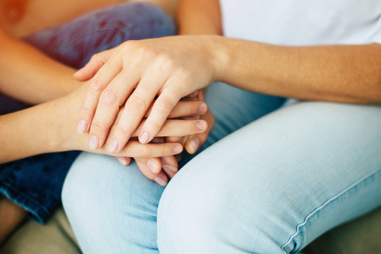 Family, age, support, help, love. Close up photo of mother and daughter hands holding each other. Moms day