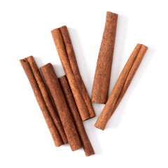 Cinnamon sticks isolated on white background closeup. Canella spice. Aromatic condiment background. Flat lay, top view.
