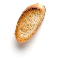 Toasted baguette slice isolated on white background close up.  Toast, crouton.   Top view.