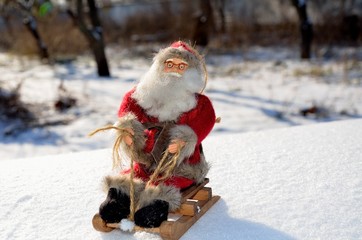 Christmas toys Santa Claus in a sleigh, in the woods, outdoors.