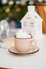 Christmas chocolate with marshmallows in the living room by the Christmas tree