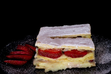 French Mille-feuille cake with fresh strawberry with isolated black background