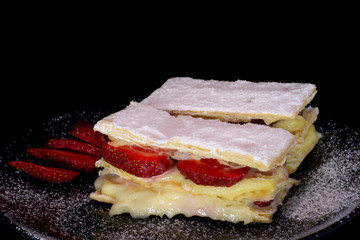 French Mille-feuille cake with fresh strawberry with isolated black background