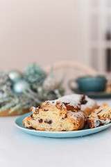 Christmas stollen with candied fruit and raisins on a festive table