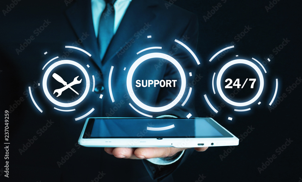 Wall mural man holding tablet. 24/7 support service