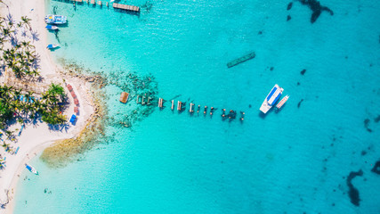 Aerial drone view of Saona Island in Punta Cana, Dominican Republic with reef, trees and beach in a tropical landscape with boats and vegetation