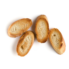Toasted baguette slices isolated on white background close up.  Toast, crouton.   Top view.