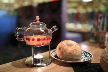 Glasses teapot with ginger tea