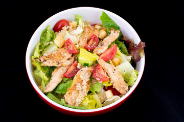 Chicken Quinoa salad with fresh vegetables with isolated black background