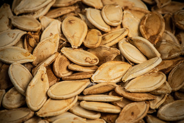 Fried pumpkin seeds, cooked in oven, macro look