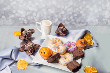 cup of coffee and a lot of different sweets