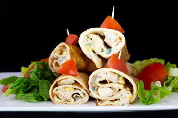 Chicken pancake with salad inside with isolated black background