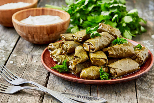 Dolma (tolma, sarma) - stuffed grape leaves with rice and meat. Traditional Caucasian, Ottoman, Turkish and Greek cuisine