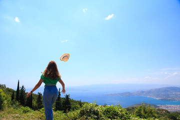 A female trying to catch her hat