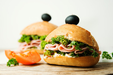 Homemade burger. Low fat turkey ham and salad sandwich, black background. Food photo.
