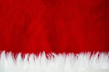 Border of white fur over festive red brocade. Lots of copy-space. Santa Claus.