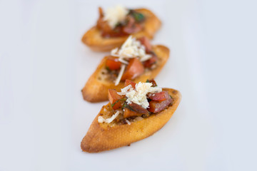 Delicious bruschetta with tomato and cheese with isolated white background