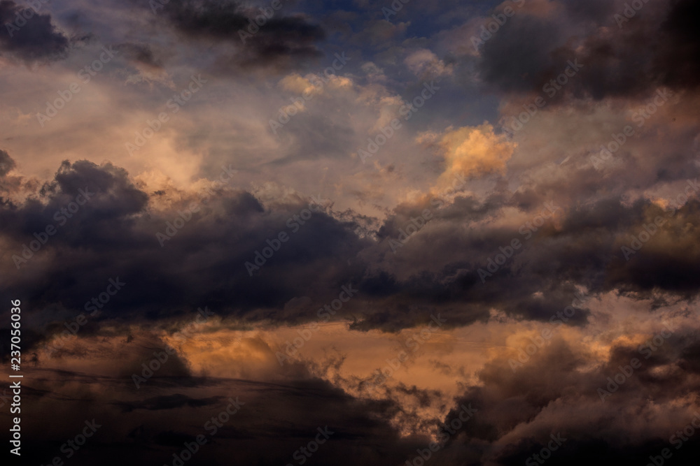 Wall mural sunset sky with dark clouds close up - texture