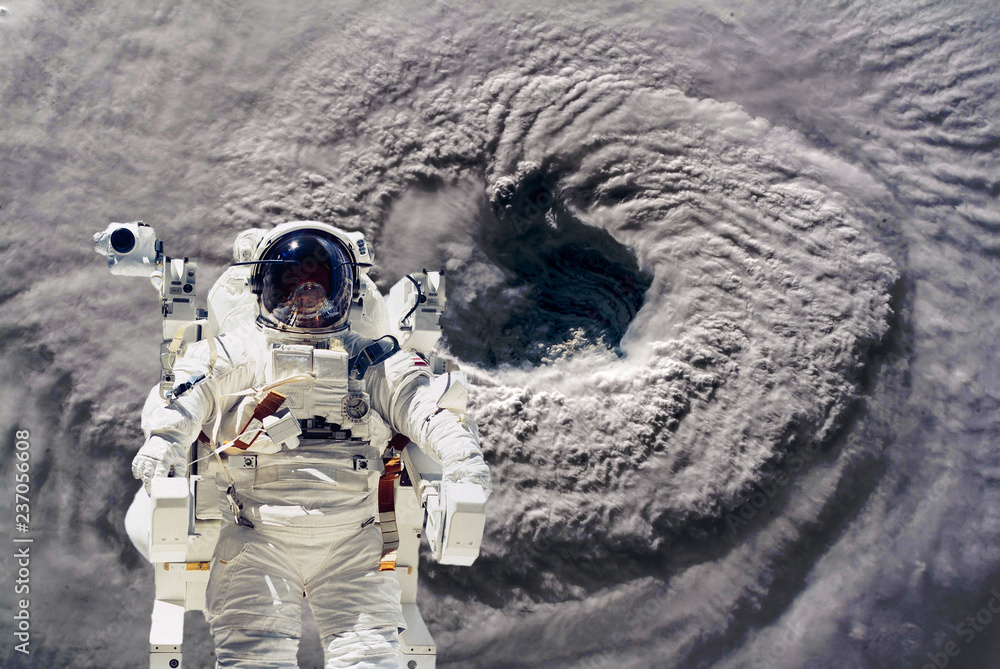 Poster astrounaut spacewalk in the space on earth orbit at night. elements of this image furnished by nasa 