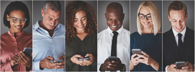 Smiling group of diverse businesspeople sending text messages